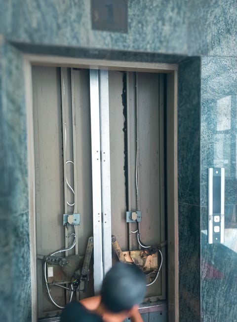 Elevator technician performing maintenance